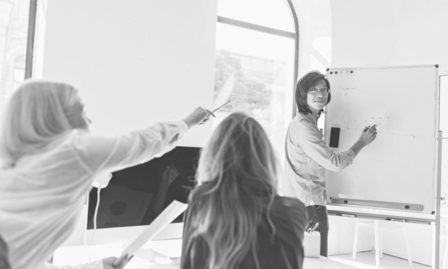 Interactive classroom environment with students working on financial models and valuation exercises